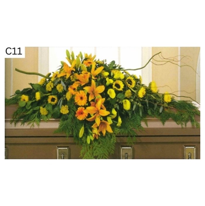 Orange Hue Lilies and Sunflowers Casket Spray